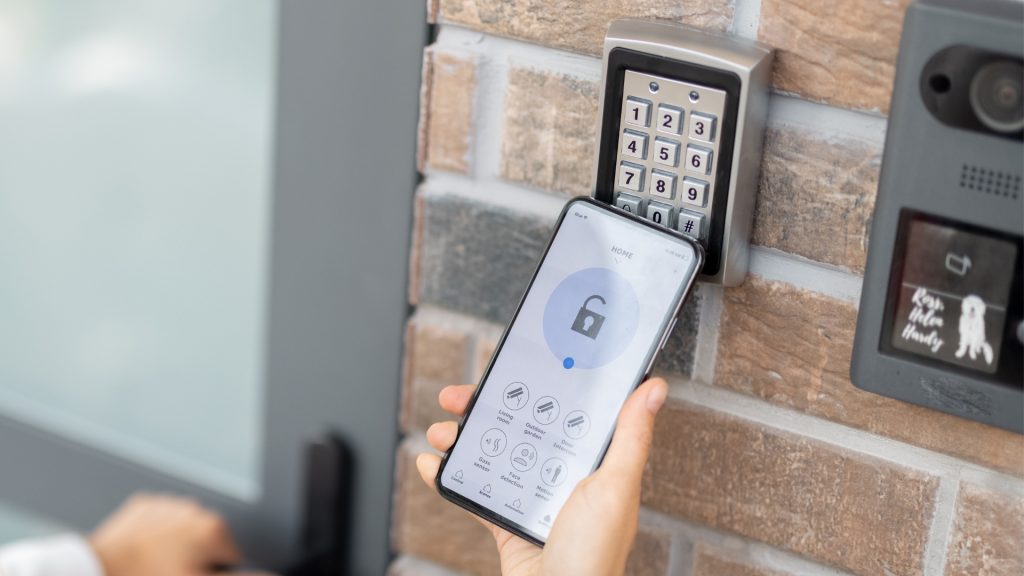 A homeowner using an electronic key to open a smart lock 