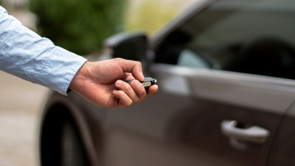 A car owner opening his car with a transponder key